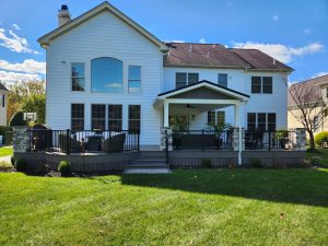 A-frame roof over Timbertech PVC deck, stone roof and deck columns, curved deck front, black aluminum railings &#8211; West Chester PA
