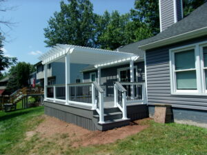 Timbertech PVC Castle Gate deck, matching skirting around the bottm, white vinyl pergola over deck – Reading PA
