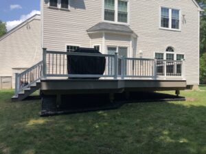 Timbertech PVC Slate Gray deck, rocks installed under deck, helical piles for footers – Garnet Valley PA