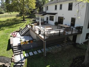 Timbertech PVC French White Oak deck with American Walnut border, black American series railing with stainless steel cable infill and an American Walnut drink rail top – Collegeville PA