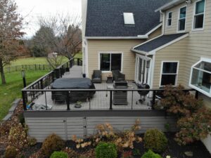 Timbertech PVC Coastline deck with Dark Hickory border, black American rail with horizontal Stainless Steel cable infill, Dark Hickory drink rail on top of railing, horizontal skirting – Lansdale PA