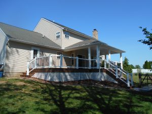 Hip- style roof trimmed out with White Vinyl, over an Azek Morado deck with Timbertech Radiance railings – Doylestown PA