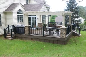 Almond Vinyl pergola with Stone columns built over a Timbertech deck – West Chester PA